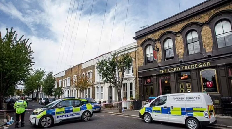 Police cars outside Lord Tredegar pub on Lichfield Road, Bow, East London, investigating Shea Gordon's murder.