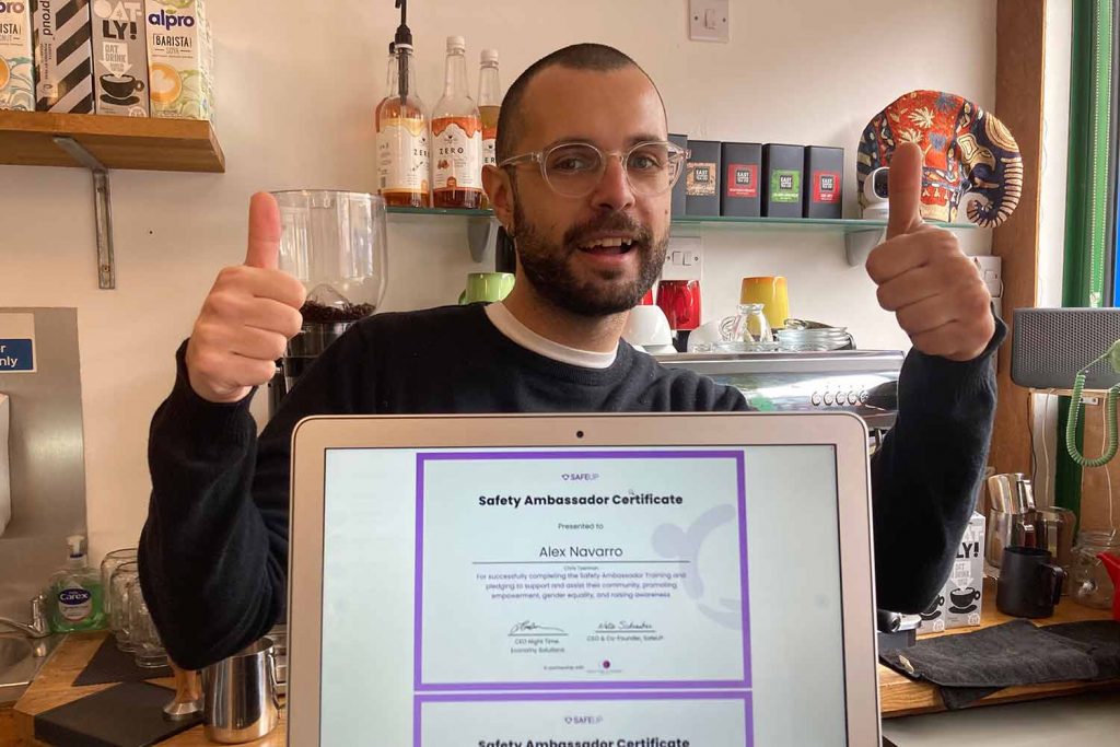 Alex Navarro, Jungle Electric barista, showing his SafeUP ambassador certificate. 
