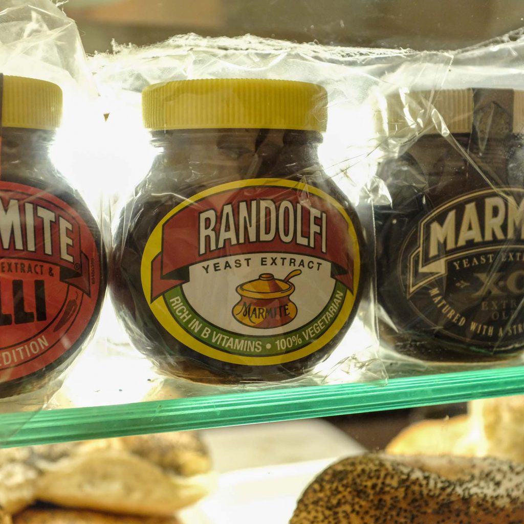 Small glass bottle of Marmite with the word 'Randolfi' written on it, where the Marmite sign would be in Randolfi's, Roman Road, Bow, East London.
