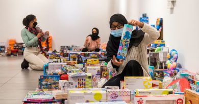 Woman sorting through toys at East London Toy Appeal, Tower Hamlets