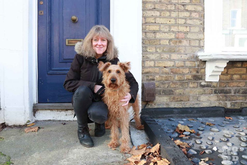 Artist Ali Smith with her dog outside their home in Bow, East London.