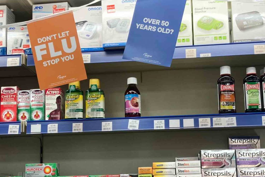 shelf of medicine cough syrup that is empty in Massingham Pharmacy