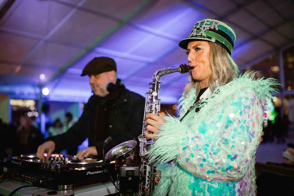 Sister Sax, live saxophonist, performing at Canary Wharf ice rink