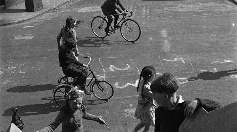 Children playing hopscotch and skipping games on Chisenhale Road in East London outside the house where Nigel Henderson used to live.