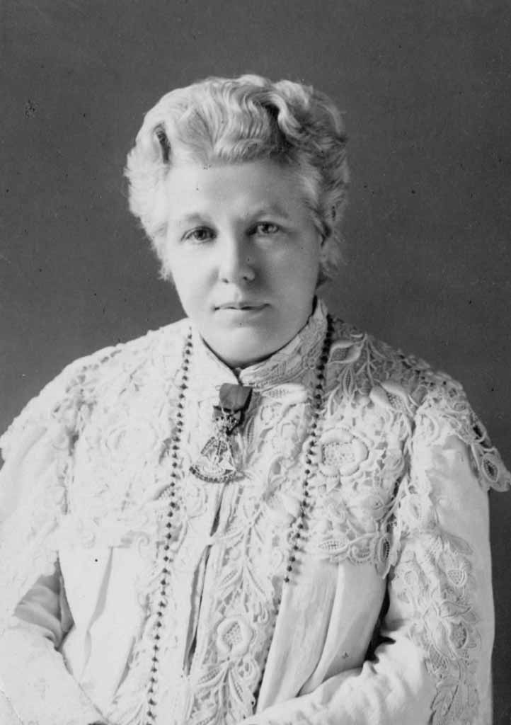 Annie Besant sitting, wearing a white blouse, in her old age.