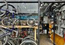 Bike shop filled with bikes and bike parts seen through shop window