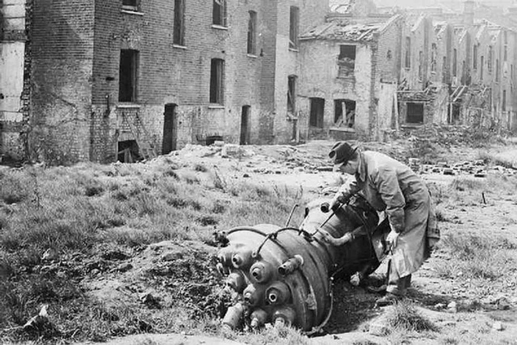 Black and white image of man discovering World War Two doodlebug in Limehouse East London.