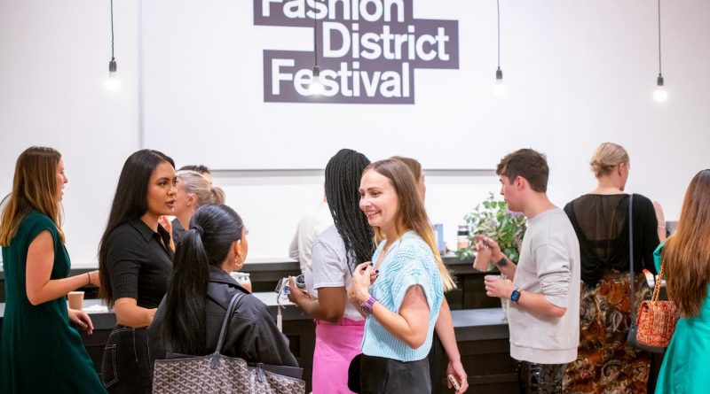 A group of people talking at the Fashion DIstrict Festival, which is making its 2023 return to Spitalfields