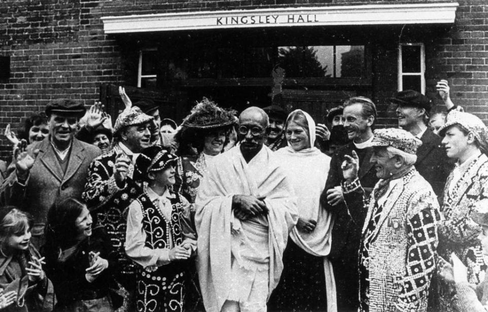 Mahatma Gandhi outside Kingsley Hall surrounded by locals
