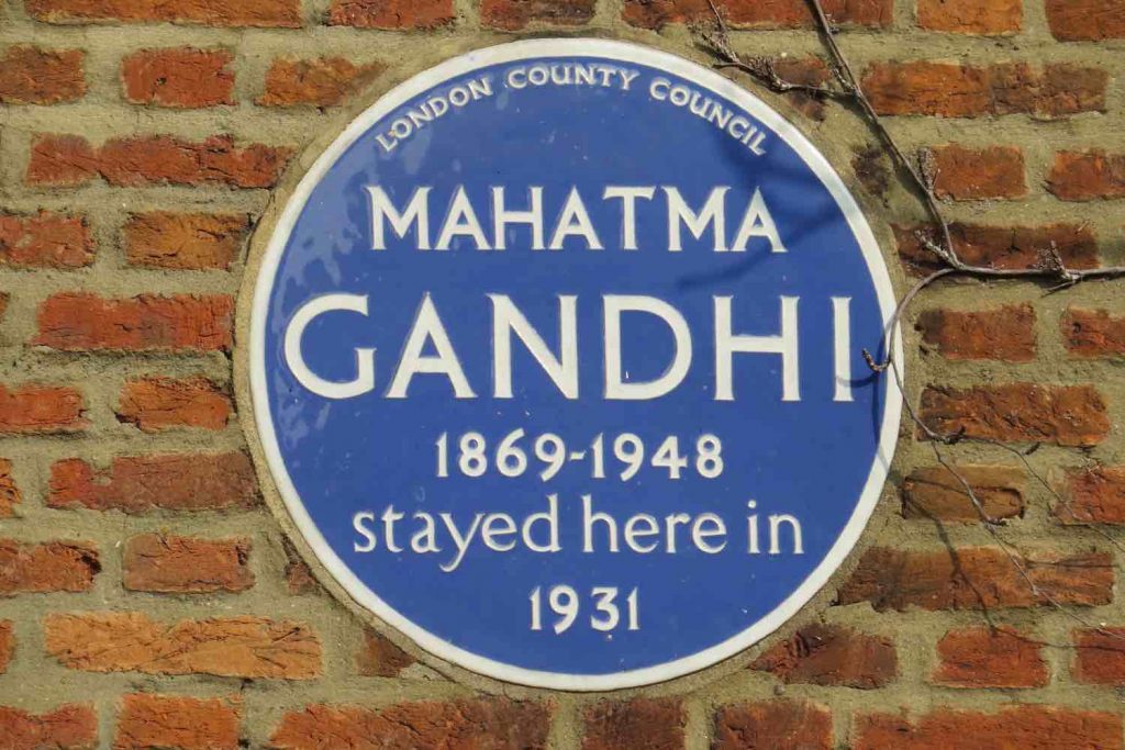 Blue plaque on brick wall of Kingsley Hall with text, "London County Council Mahatma Gandhi 1869-1948 stayed here in 1931"