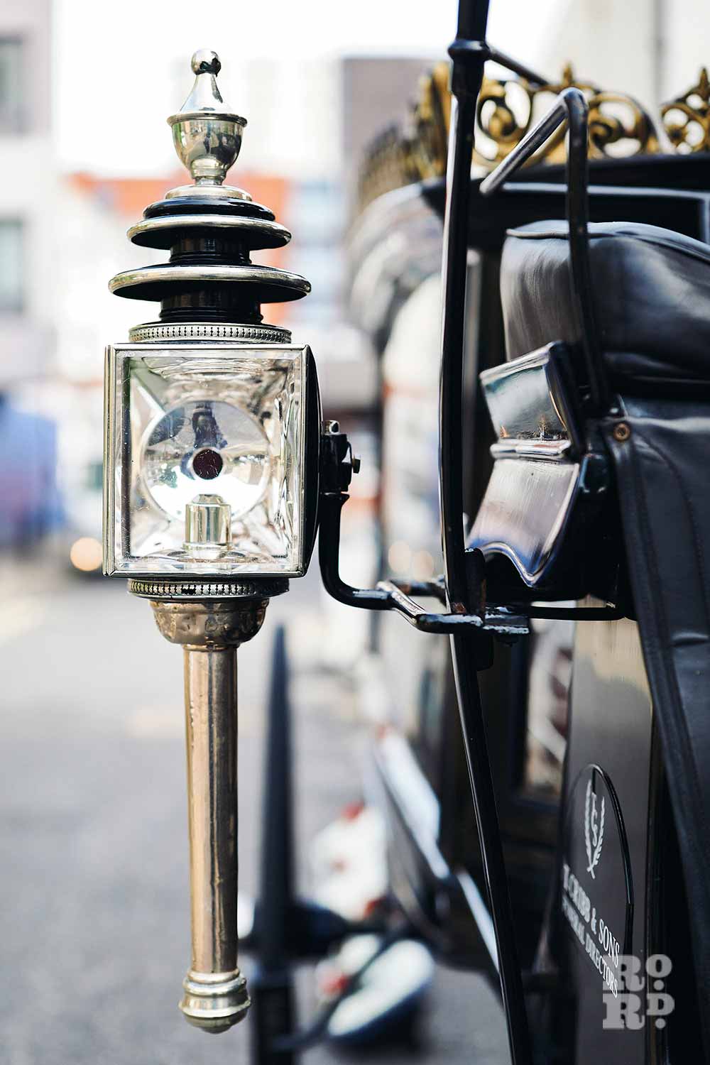 Lamp on a black funeral carriage.