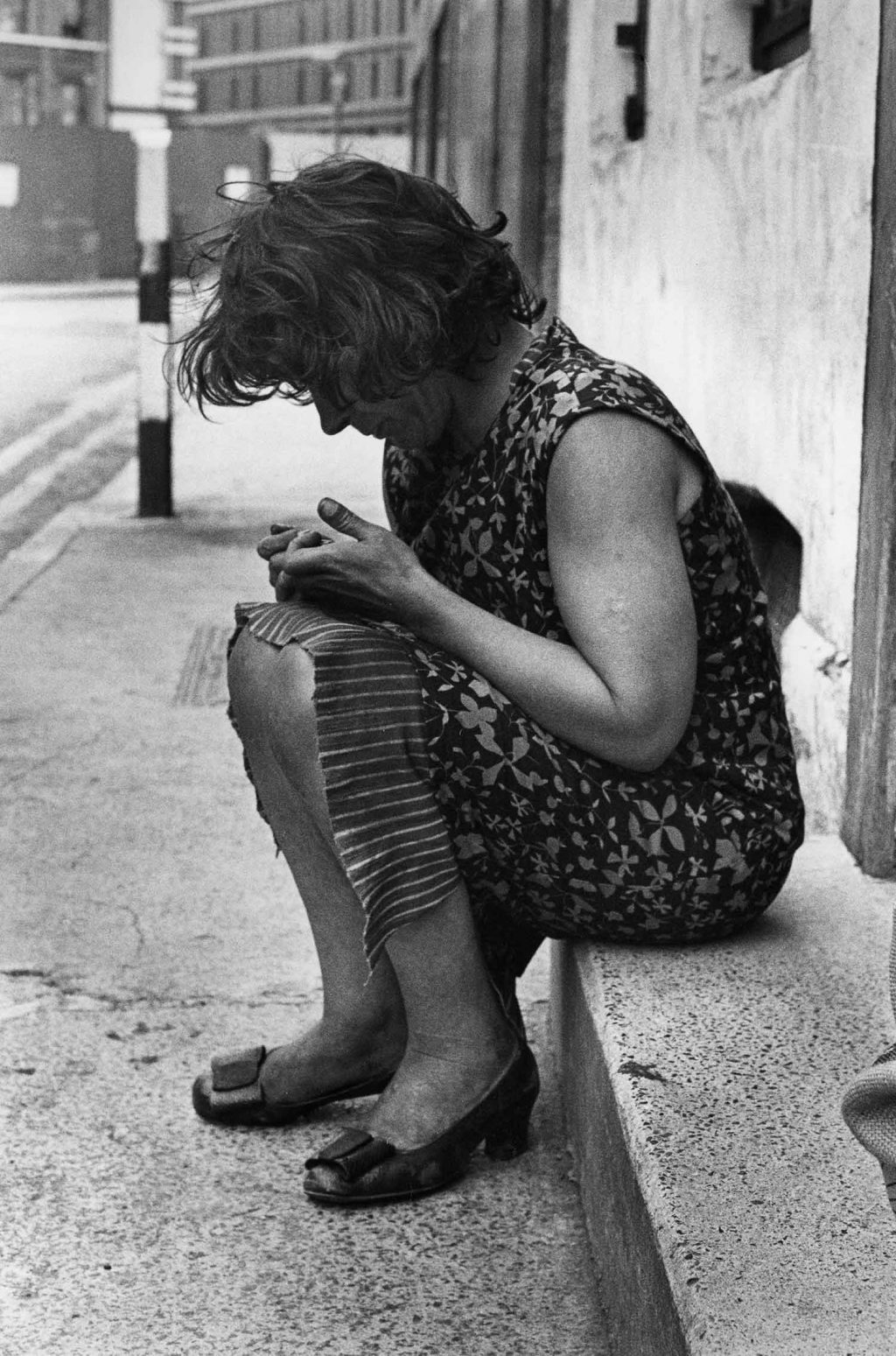 A photograph of a woman called Sylvia in Tenterground, Spitalfields in 1970s: Images of Housing, Homelessness and Resistance in London's East End, from the Conditions of Living exhibition at Four Corners.