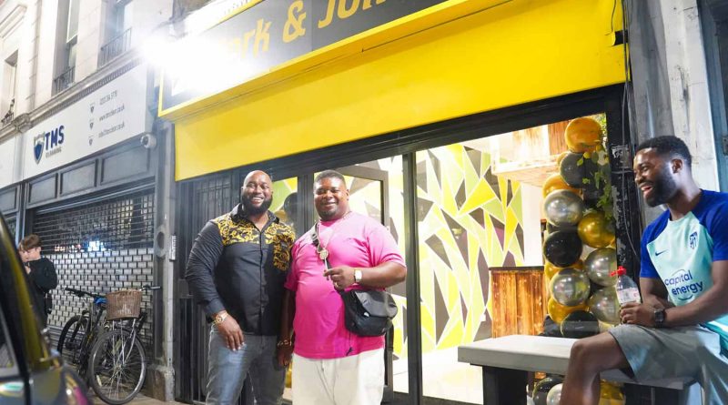 Big Narstie Grime MC and the owner of Jerk and Jollof, Chuks, standing outside the restaurant on Roman Road at its opening evening.