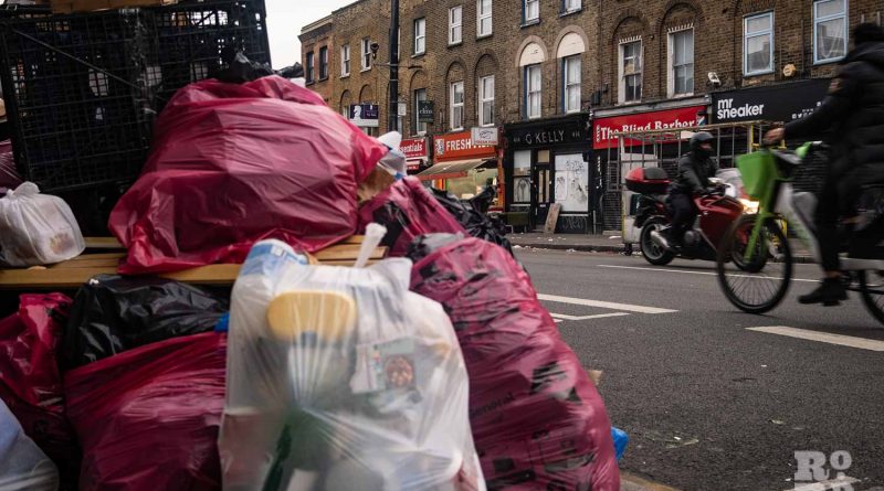 GKelly in the background of piles of rubbish during the Tower Hamlets refuse worker strikes in 2023.
