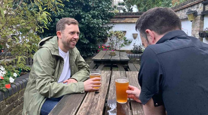 Photographer, Tim George, chatting to Ali Von Lion 'London Pub Explorer' over a pint in the Young Prince's beer garden on Roman Road.