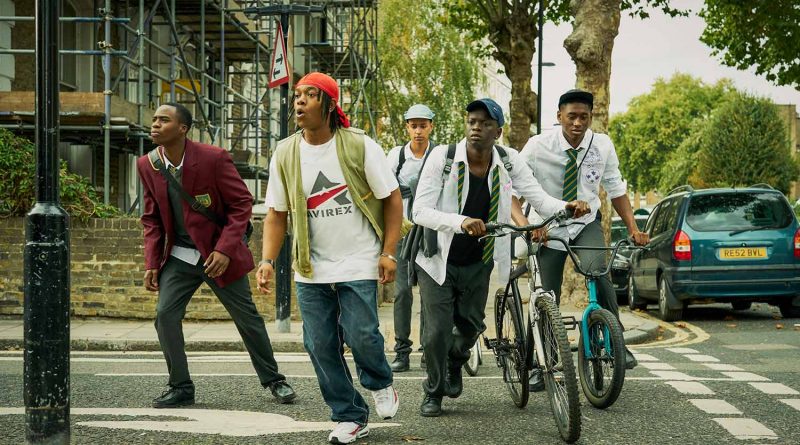 Cast members of BBC Three's Grime Kids; five teenage boys crossing a street in East London with their bikes.