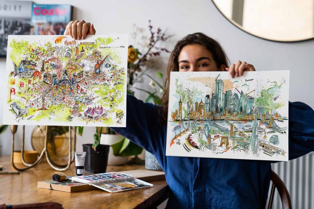 Artist Naomi Bailey aka Wanderrover with paintings of Glastonbury and the City of London