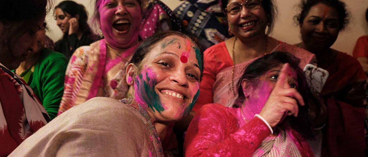Women with colour painted faces, Holi festival, or Dolyatra, at the Hindu Pragati Sangha in Bow. Photography by Alice Sacco © Social Streets CIC