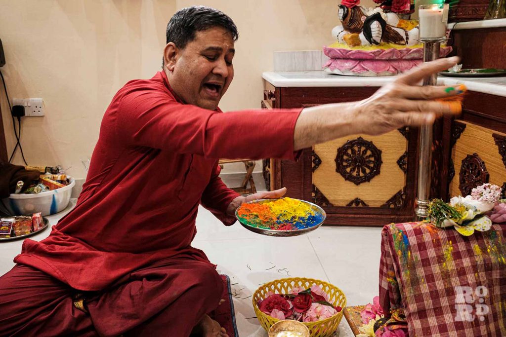 A celebrant throwing pigment at Holi Day festival, or Dolyatra, at the Hindu Pragati Sangha in Mile End, East London.