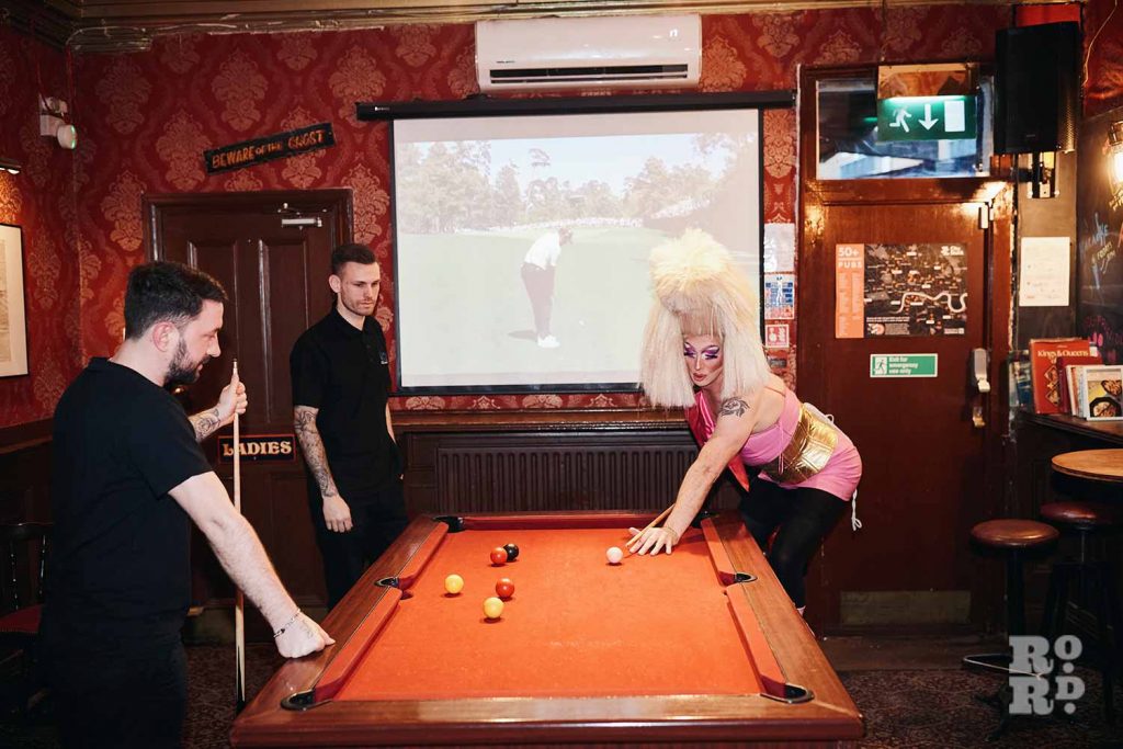 Christina Draguilera playing pool with two men at the Bow Bells pub