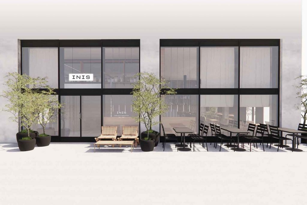 A mock-up of the exterior of INIS on the canalside in Hackney Wick, with wall-length windows, outdoor seating and green trees
