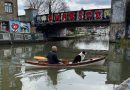 Dog adnd man on a kayak, cruising into Hackney Wick, East London