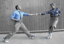 Two dancers with blue outfits dancing Lindy Hop in a class, East London
