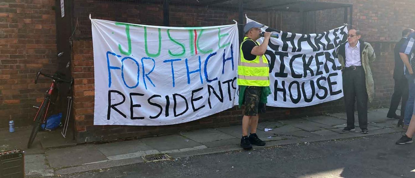 Tower Hamlets Community Homes residents protesting with a banner against the proposed merger with Poplar HARCA