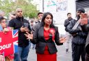Uma Kumaran, Labour Party candidate for Stratford and Bow in Tower Hamlets and Newham, in a 'Labour' red dress with matching red rosette, talking to by standers on the streets.