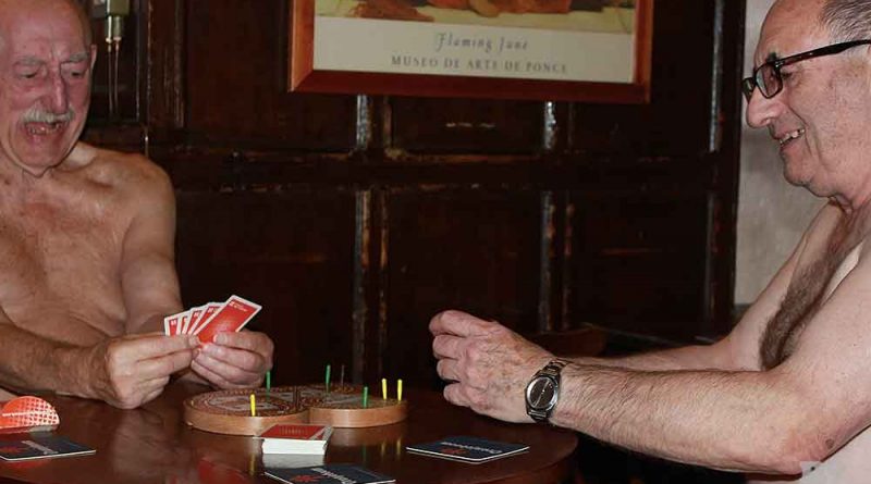 Two elderly men baring all playing cribbage in an East End pub in London.