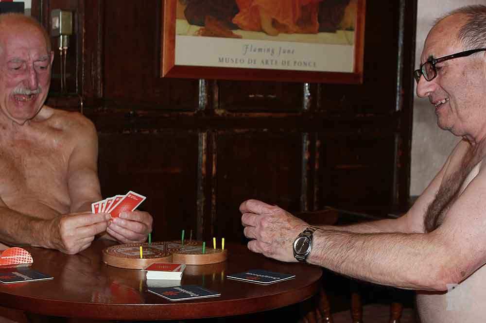 Two elderly men baring all playing cribbage in an East End pub in London.