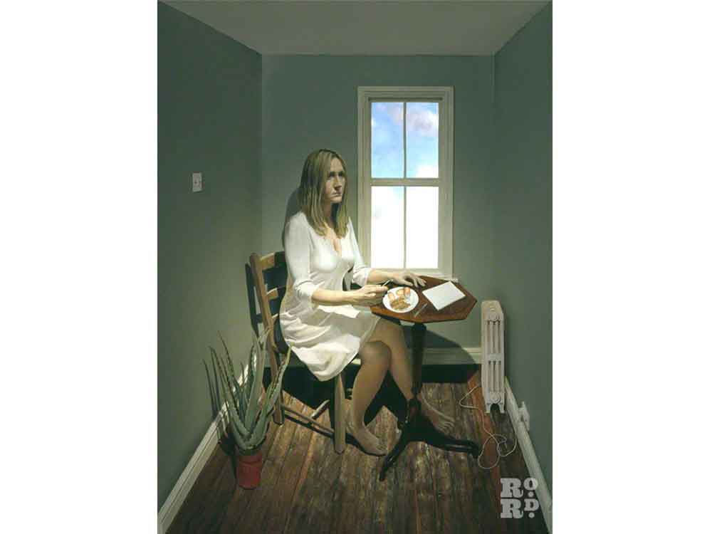 Portrait of JK Rowling sitting at a table in a narrow green-painted room, by artist Stuart Pearson Wright.