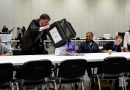 Officials emptying ballot papers onto a table for counting, Tower Hamlets General Elections 2024, at Excel.